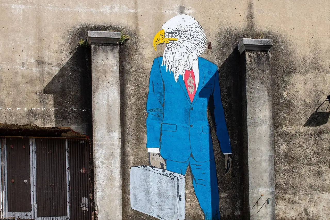 Street-art mural of an eagle-headed businessman in a blue suit on a concrete wall in Lisbon