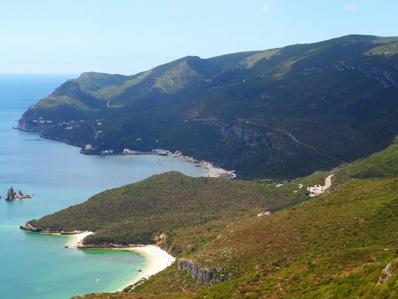 Green Arrábida hills above a turquoise bay and sandy cove on the coast near Setúbal