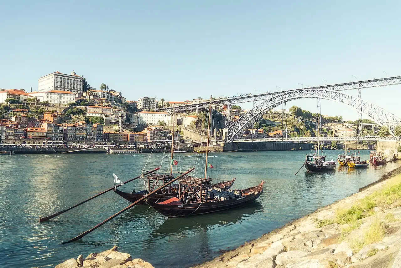 Rabelo boats on the Douro in Porto, with the Dom Luís I bridge and Ribeira houses behind