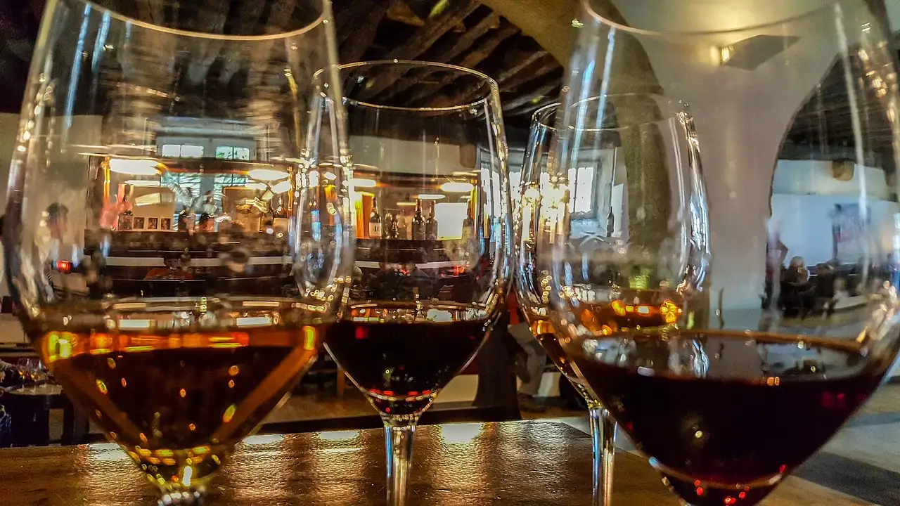 Glasses of tawny and red port wine on a bar in warm light