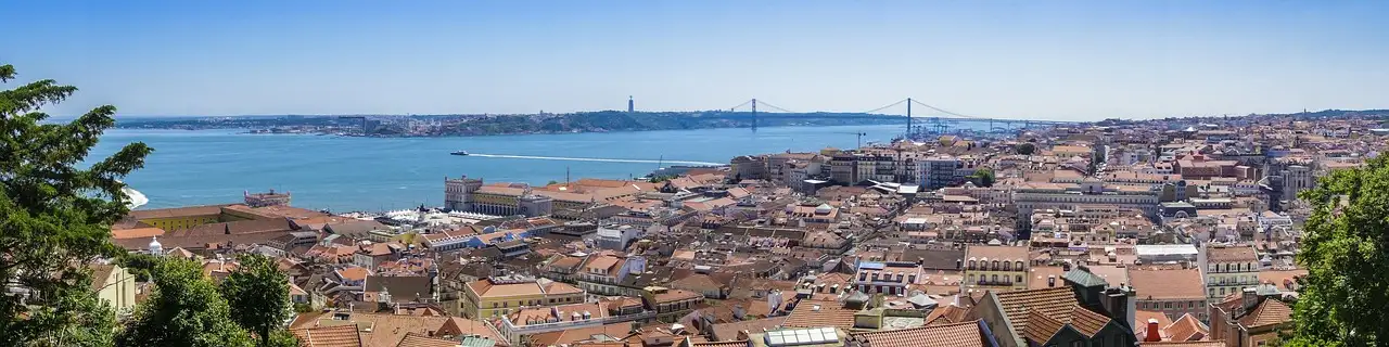 Panorama over Lisbon's rooftops to the Tagus river and the bridge