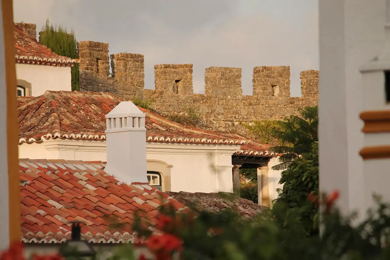 Medieval walls of Óbidos above terracotta roofs and whitewashed houses