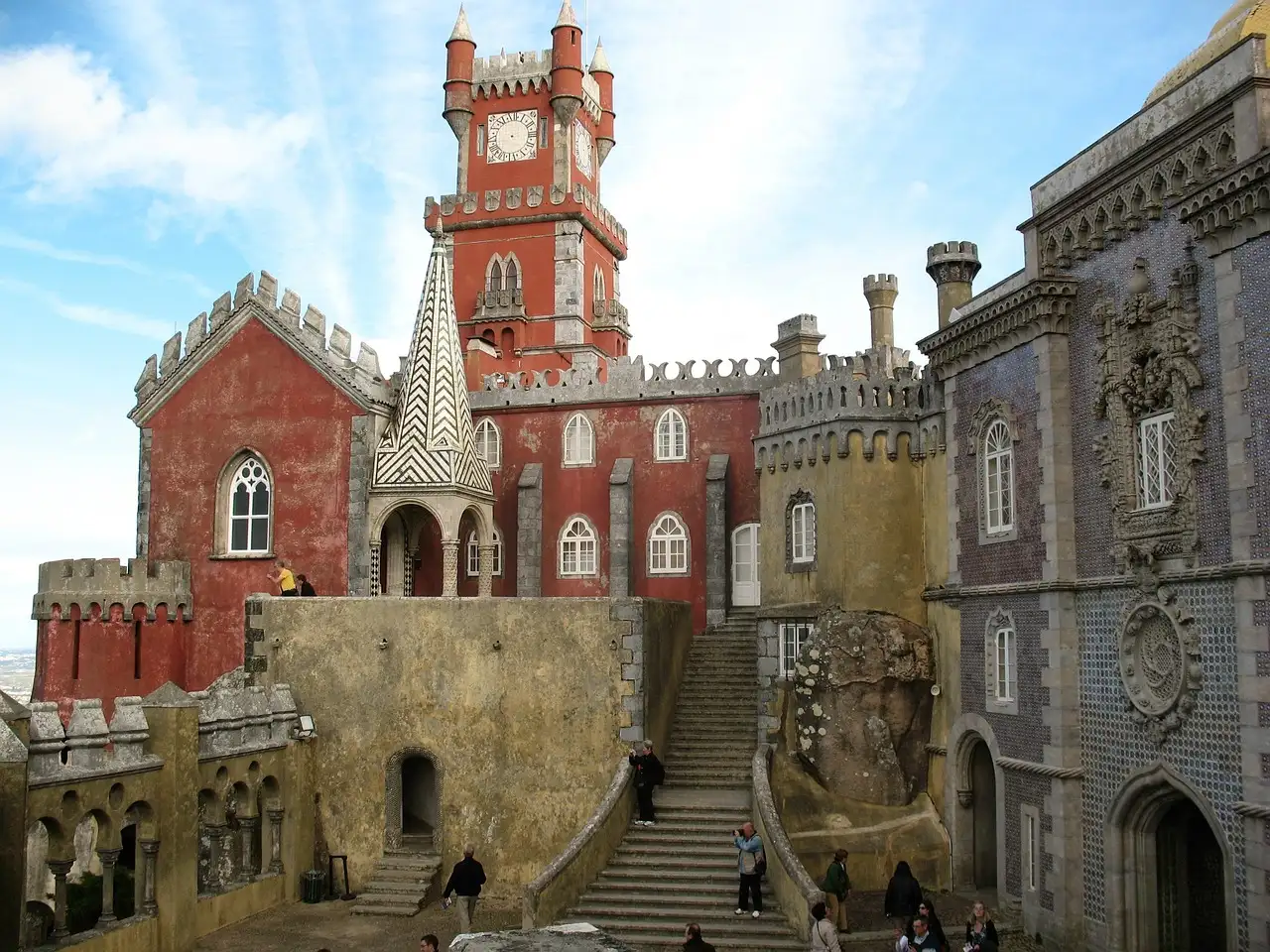 Terrace and red clock tower of Pena Palace in Sintra, with stone steps and ornate walls