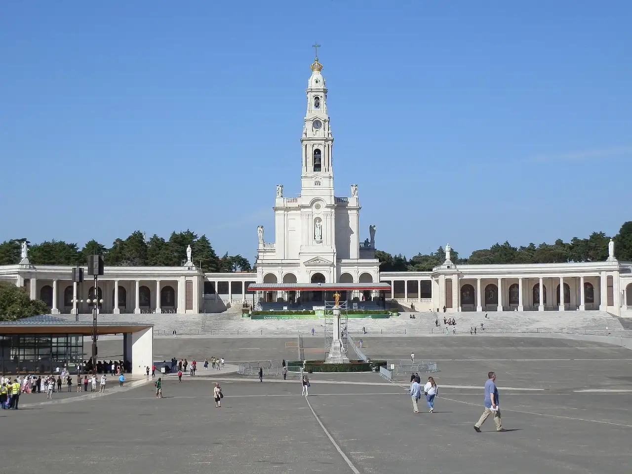 Fátima sanctuary square with the basilica and its tower at the far end under a blue sky