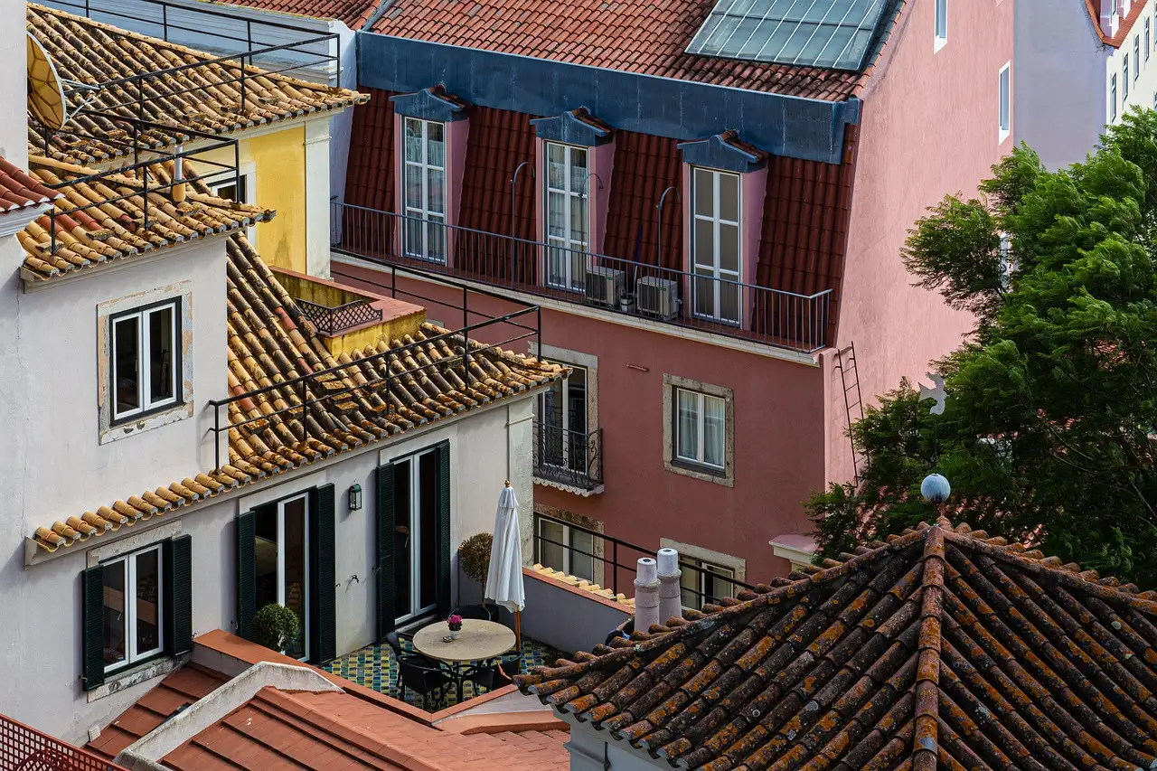 Colourful old Lisbon houses with balconies and red tiled roofs