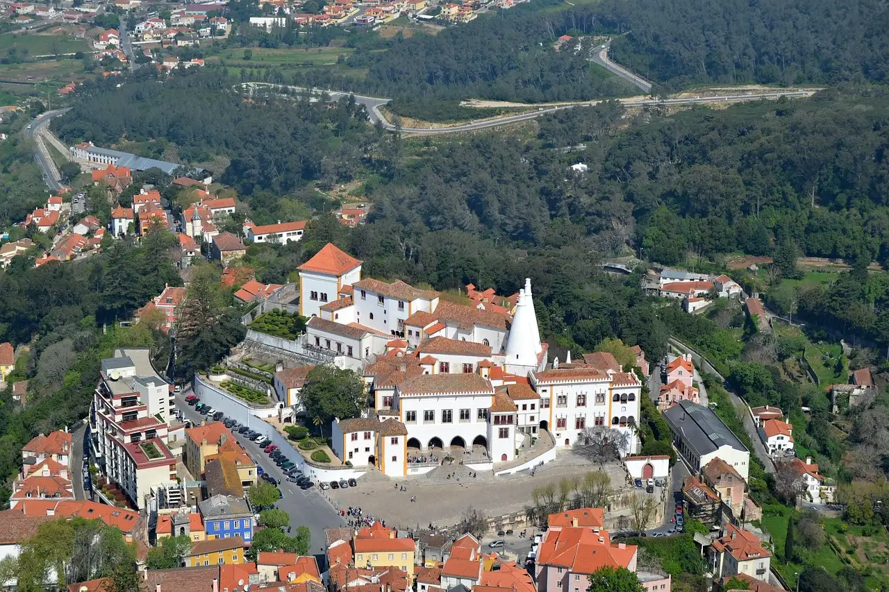 Sintra's old town from above, with the National Palace's two white conical chimneys among red roofs